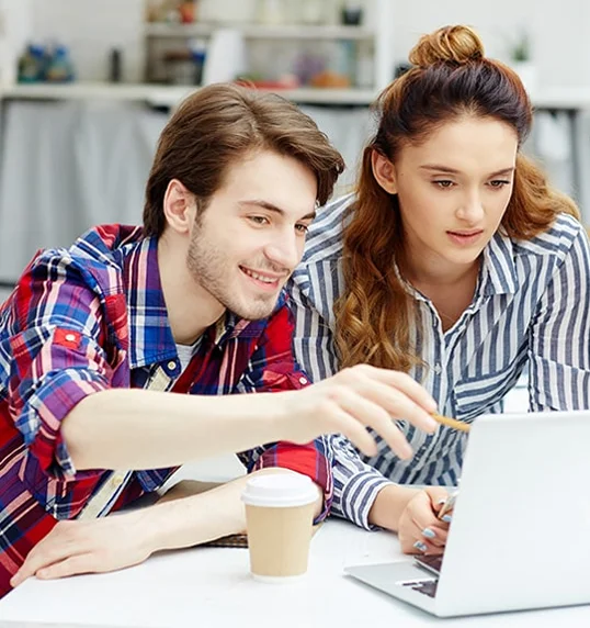 A team collaborating around a laptop